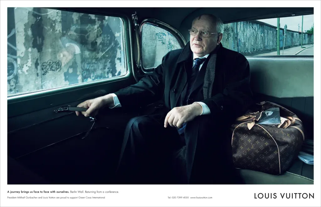 Mikhail Gorbachev in a Louis Vuitton advertisement, Berlin Wall visible through the car window